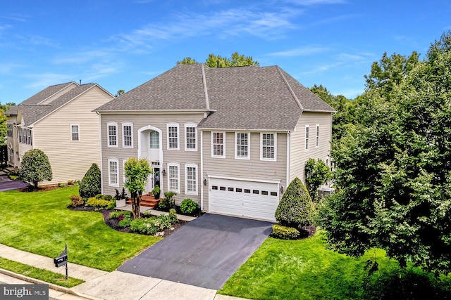 42863 Glyndebourne Ct, Broadlands, VA 20148 - view of front of home featuring driveway, a front yard, a garage, and a shingled roof
