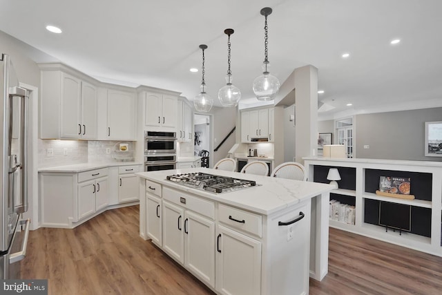 42863 Glyndebourne Ct, Broadlands, VA 20148 - kitchen with stainless steel appliances, recessed lighting, white cabinetry, decorative backsplash, and a center island