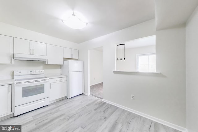 6952 Hanover Pkwy Unit 300, Greenbelt, MD 20770 - kitchen featuring white appliances, under cabinet range hood, light countertops, and white cabinets
