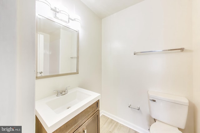 6952 Hanover Pkwy Unit 300, Greenbelt, MD 20770 - bathroom featuring vanity, toilet, wood finished floors, and baseboards