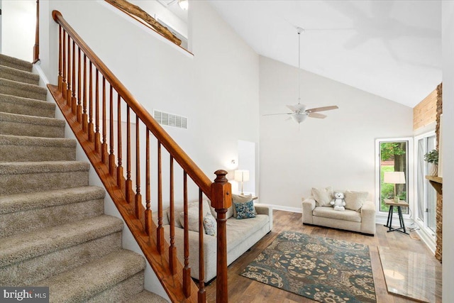 6816 Balmoral Ct, New Market, MD 21774 - living room with stairway, wood finished floors, high vaulted ceiling, a ceiling fan, and baseboards