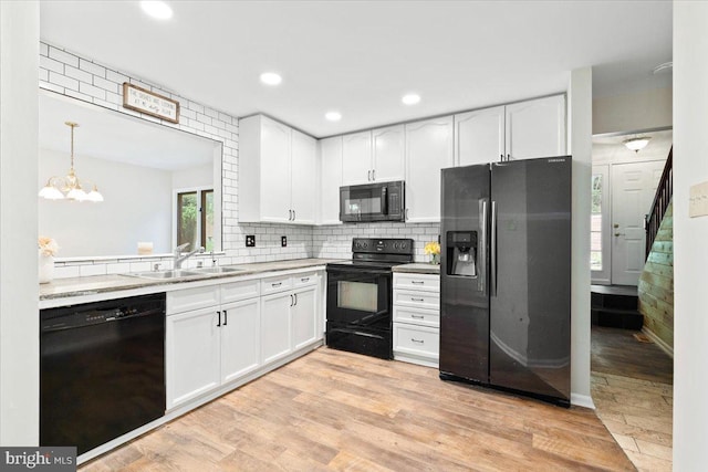 6816 Balmoral Ct, New Market, MD 21774 - kitchen featuring black appliances, white cabinets, a sink, and recessed lighting