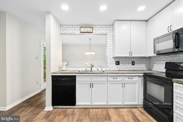6816 Balmoral Ct, New Market, MD 21774 - kitchen featuring black appliances, a sink, backsplash, white cabinets, and recessed lighting