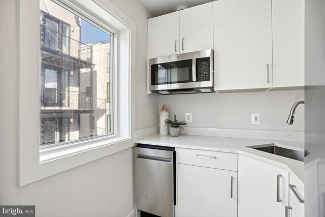 1746 Lanier Pl NW Unit 2, Washington, DC 20009 - kitchen featuring stainless steel appliances, a sink, and white cabinetry