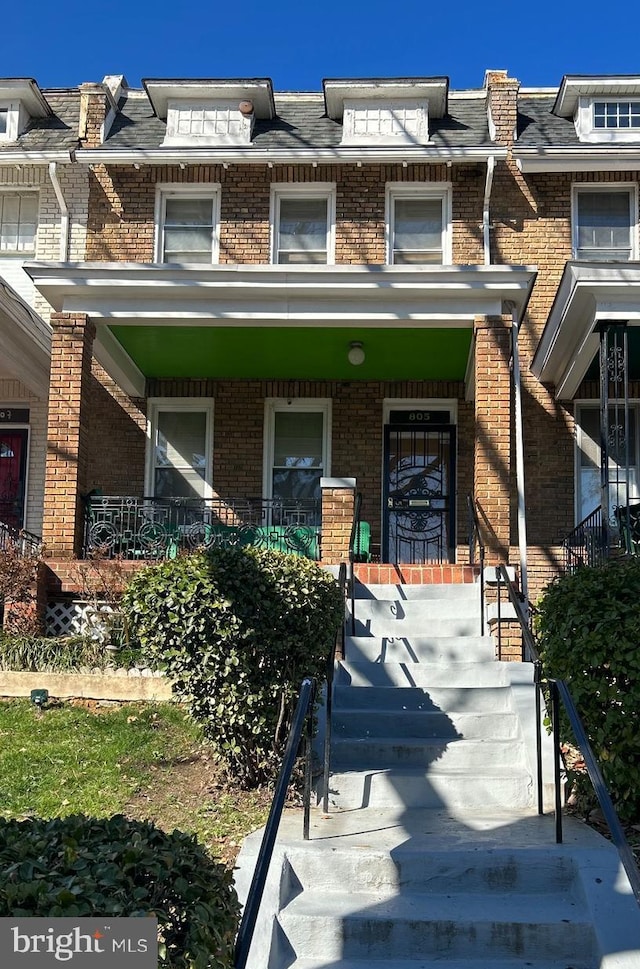 805 Longfellow St NW, Washington, DC 20011 - view of front of property featuring brick siding, a porch, and mansard roof