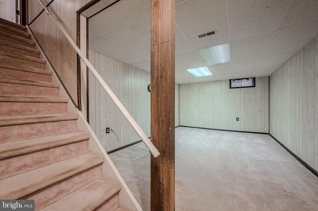 4861 Plum Run Ct, Wilmington, DE 19808 - finished below grade area featuring a drop ceiling, stairway, carpet flooring, baseboards, and wooden walls