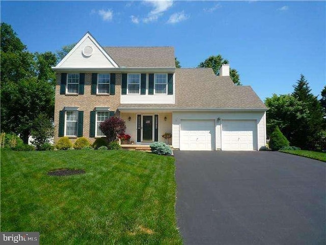 8 Spur Ridge Ct, Newark, DE 19702 - colonial home featuring a garage, a chimney, driveway, and a front yard