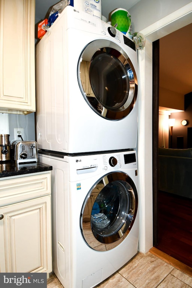 11839 Shire Ct Unit 31D, Reston, VA 20191 - laundry room featuring stacked washer / dryer and light wood-type flooring