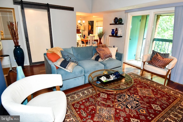 11839 Shire Ct Unit 31D, Reston, VA 20191 - living area featuring wood finished floors, a chandelier, and a barn door