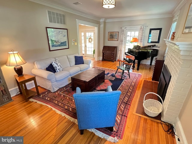 6206 Pinehurst Rd, Baltimore, MD 21212 - living room with wood-type flooring, a brick fireplace, ornamental molding, and baseboards