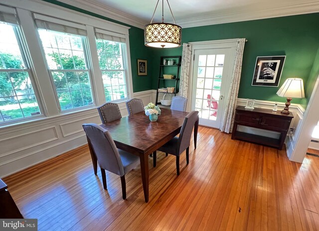 6206 Pinehurst Rd, Baltimore, MD 21212 - dining area with a decorative wall, crown molding, wainscoting, and light wood finished floors