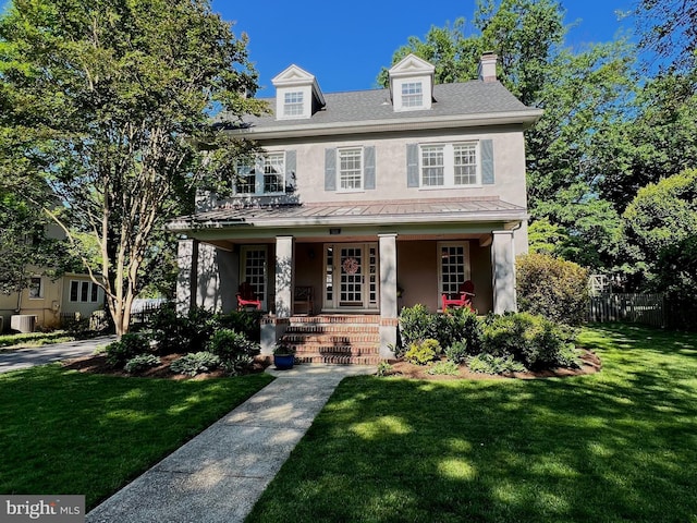 6206 Pinehurst Rd, Baltimore, MD 21212 - view of front facade with stucco siding, covered porch, a standing seam roof, a chimney, and metal roof