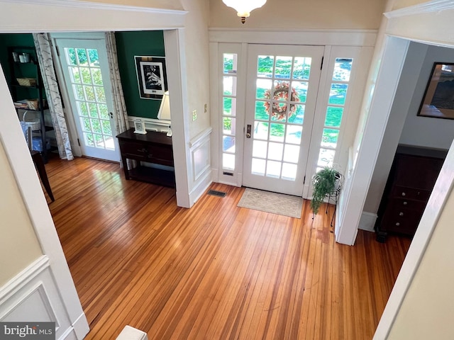 6206 Pinehurst Rd, Baltimore, MD 21212 - entrance foyer featuring a decorative wall, light wood-style floors, and wainscoting