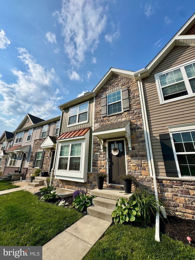 4215 Wild Orchid Ln, Enola, PA 17025 - townhome / multi-family property featuring stone siding and a front lawn