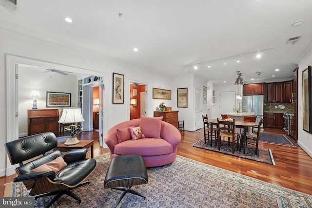 1023 N Royal St Unit 207, Alexandria, VA 22314 - living area with wood finished floors, crown molding, recessed lighting, baseboards, and track lighting
