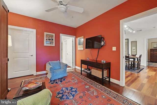 1023 N Royal St Unit 207, Alexandria, VA 22314 - living area with wood finished floors, baseboards, a ceiling fan, and track lighting