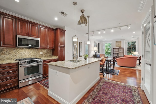 1023 N Royal St Unit 207, Alexandria, VA 22314 - kitchen featuring stainless steel appliances, a sink, ornamental molding, dark wood finished floors, and decorative backsplash
