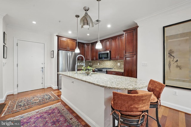1023 N Royal St Unit 207, Alexandria, VA 22314 - kitchen featuring appliances with stainless steel finishes, light wood-style flooring, a sink, tasteful backsplash, and light stone countertops