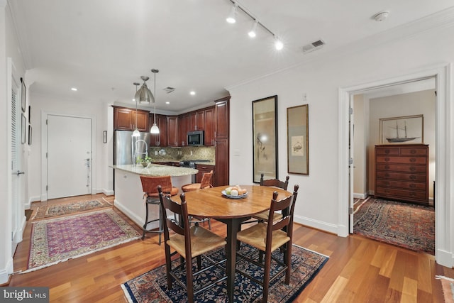 1023 N Royal St Unit 207, Alexandria, VA 22314 - dining area featuring light wood-style flooring, track lighting, crown molding, baseboards, and recessed lighting