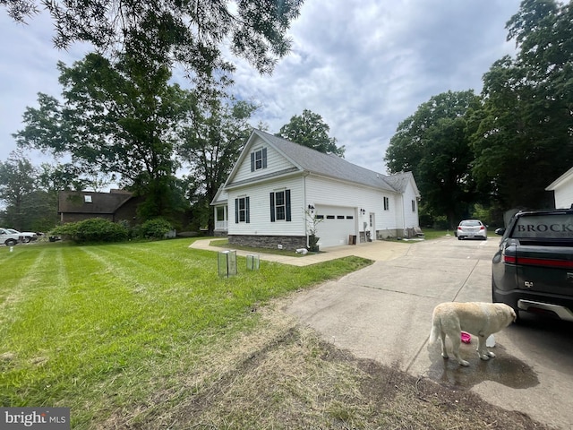 10963 Poplar Dr, Lusby, MD 20657 - view of side of property featuring a yard, a garage, and concrete driveway