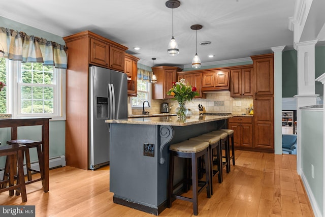 872 Kilby Dr, Yardley, PA 19067 - kitchen with stainless steel refrigerator with ice dispenser, light wood-type flooring, light stone counters, tasteful backsplash, and ornamental molding