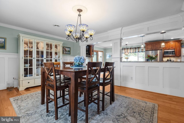 872 Kilby Dr, Yardley, PA 19067 - dining room featuring a decorative wall, a chandelier, crown molding, wainscoting, and light wood-type flooring