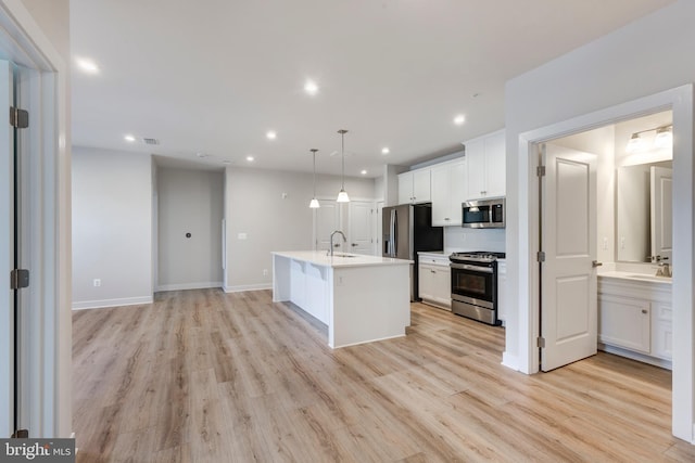 42 Liberty Rd Unit M, Sykesville, MD 21784 - kitchen with appliances with stainless steel finishes, light wood-style floors, a sink, white cabinetry, and recessed lighting