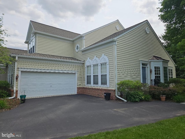 11 Musket Ct Unit 53, West Chester, PA 19380 - view of front facade featuring asphalt driveway and a garage