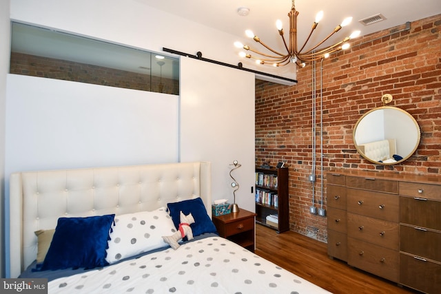 57 N St NW Unit 301, Washington, DC 20001 - bedroom featuring brick wall, wood finished floors, and a chandelier
