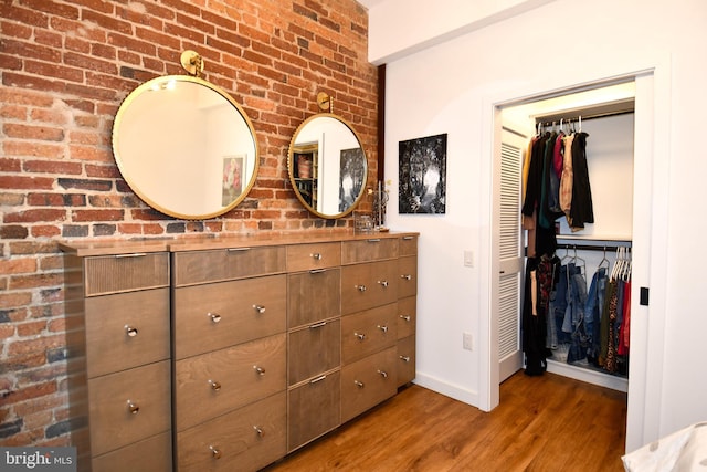 57 N St NW Unit 301, Washington, DC 20001 - bedroom with wood finished floors, a closet, and brick wall