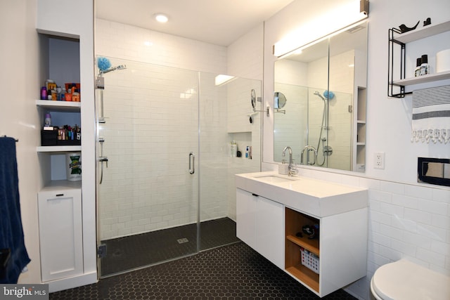 57 N St NW Unit 301, Washington, DC 20001 - bathroom with a shower stall, vanity, tile patterned flooring, and tile walls