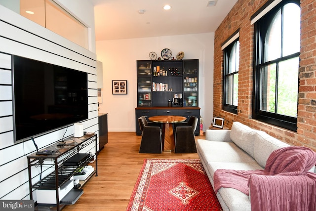 57 N St NW Unit 301, Washington, DC 20001 - living room with light wood-type flooring, bar area, brick wall, and recessed lighting
