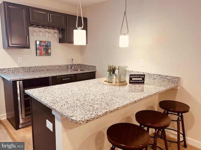 420 Bellflower Way Merion Plan, Unit Merion Plan, Townsend, DE 19734 - kitchen featuring a peninsula, a sink, a breakfast bar area, and baseboards
