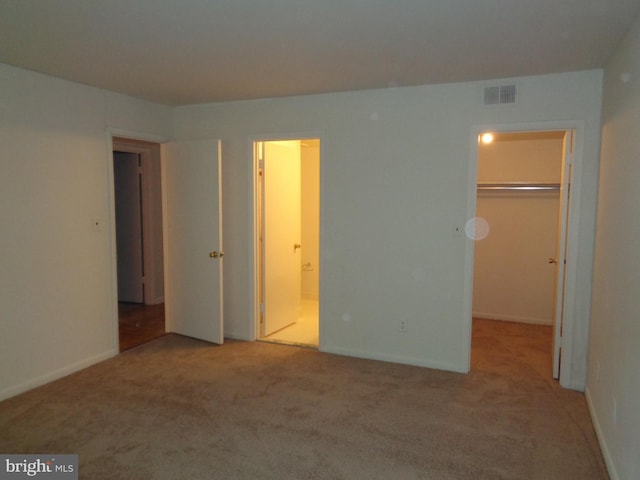 6 Bailiffs Ct Unit 301, Lutherville Timonium, MD 21093 - unfurnished bedroom featuring carpet, a walk in closet, ensuite bath, and a closet