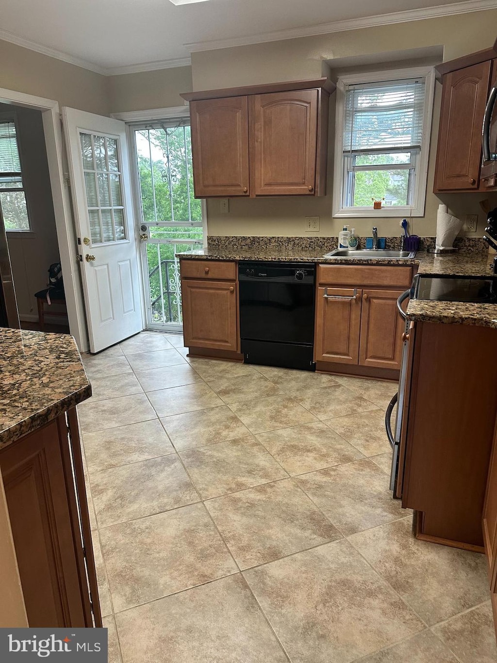 2010 Jameson St, Temple Hills, MD 20748 - kitchen with black dishwasher, range, ornamental molding, dark stone countertops, and a sink