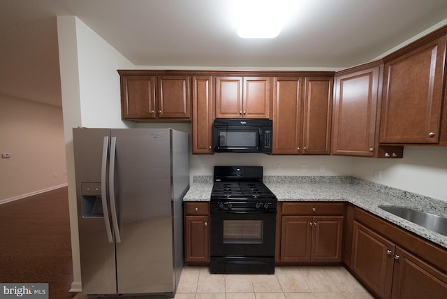 1115 Halifax Pl, Hamilton, NJ 08619 - kitchen with black appliances, light stone counters, and light tile patterned flooring