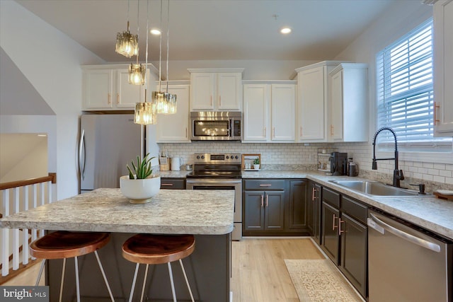 524 Charles Ave, Hanover, PA 17331 - kitchen with stainless steel appliances, a sink, white cabinets, a kitchen breakfast bar, and recessed lighting
