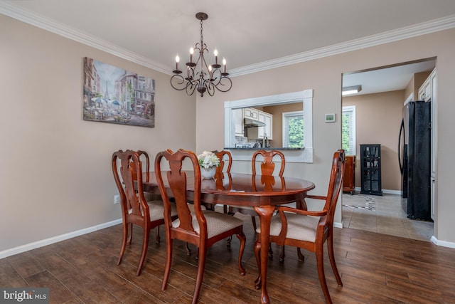1520 Villa Rd, Wilmington, DE 19809 - dining space featuring a chandelier, light wood-type flooring, crown molding, and baseboards