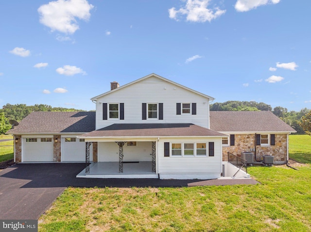 977 W Parkins Mill Rd, Winchester, VA 22602 - view of front facade featuring a porch, asphalt driveway, a front yard, a chimney, and stone siding