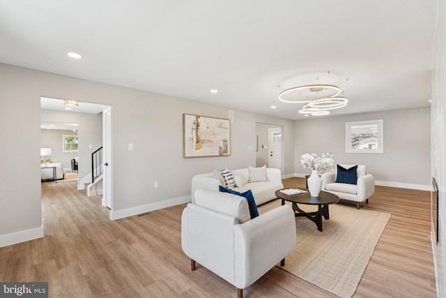 977 W Parkins Mill Rd, Winchester, VA 22602 - living room featuring light wood-style floors, a chandelier, stairway, and recessed lighting