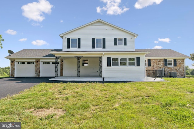 977 W Parkins Mill Rd, Winchester, VA 22602 - view of front of house featuring a porch, an attached garage, asphalt driveway, a front yard, and stone siding