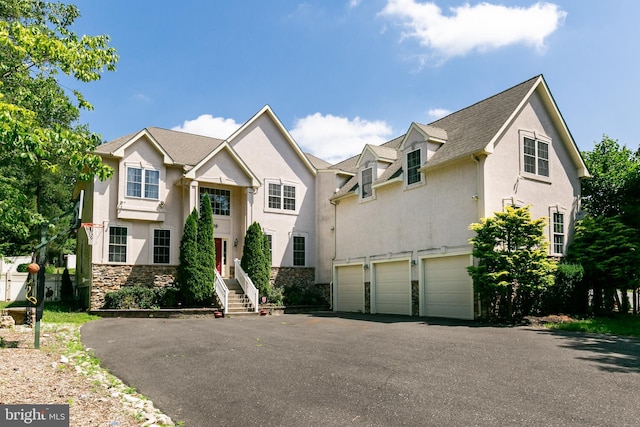 99 Kresson Gibbsboro Rd, Voorhees, NJ 08043 - view of front facade with stone siding, stucco siding, an attached garage, and driveway