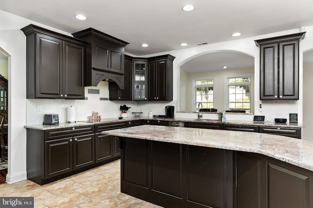 99 Kresson Gibbsboro Rd, Voorhees, NJ 08043 - kitchen with arched walkways, a sink, recessed lighting, light stone counters, and glass insert cabinets