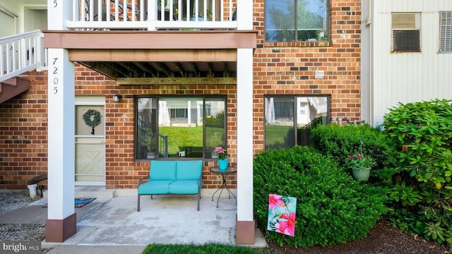 7205 Hilltop Dr Unit 95, Brookhaven, PA 19015 - doorway to property with brick siding and a balcony