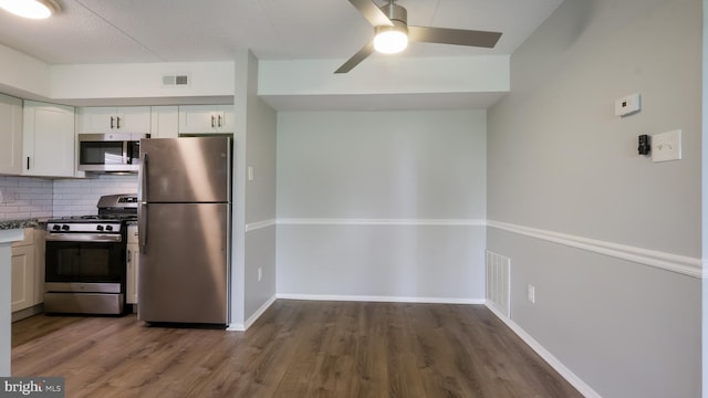 7205 Hilltop Dr Unit 95, Brookhaven, PA 19015 - kitchen featuring stainless steel appliances, ceiling fan, decorative backsplash, white cabinetry, and wood finished floors