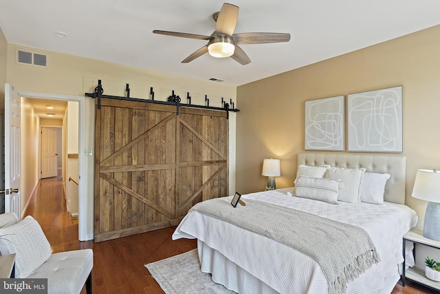 1708 Webster St, Baltimore, MD 21230 - bedroom featuring wood finished floors, a ceiling fan, and a barn door
