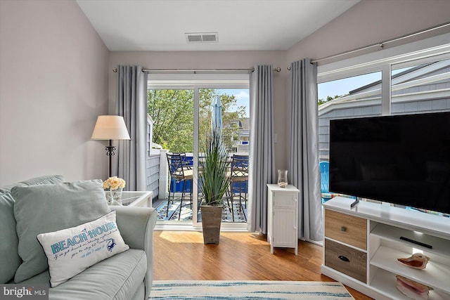 39770 E Sun Dr Unit 125, Fenwick Island, DE 19944 - living room with plenty of natural light, wood finished floors, and lofted ceiling