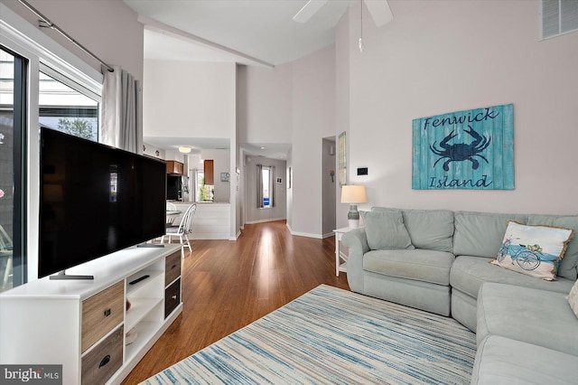 39770 E Sun Dr Unit 125, Fenwick Island, DE 19944 - living area featuring dark wood-style flooring, healthy amount of natural light, a ceiling fan, and a high ceiling