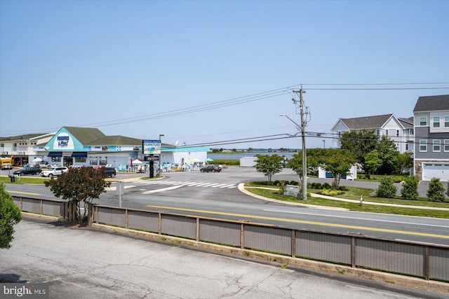 39770 E Sun Dr Unit 125, Fenwick Island, DE 19944 - view of asphalt road featuring street lights, sidewalks, and curbs