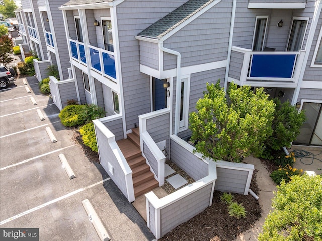 39770 E Sun Dr Unit 125, Fenwick Island, DE 19944 - exterior space with uncovered parking and a shingled roof